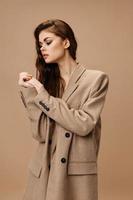 women model in coat joined hands and face makeup hairstyle photo