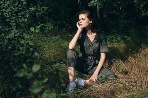 woman in the woods sitting on the grass rest fresh air photo