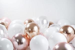 Pink gold and white balloon on white background with copy space. photo