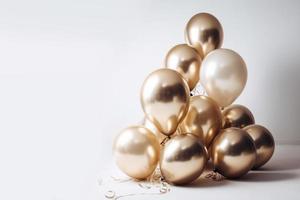 Gold and white balloon on white background with copy space. photo