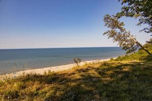 view from the escarpment to the beach on the Baltic Sea on a summer day with people photo