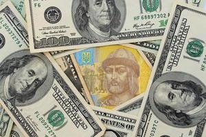 Background banknotes of us dollars and Ukrainian hryvnia photo