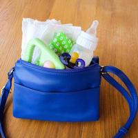 Women's handbag with items to care for the child photo