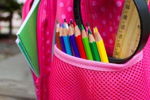 Stationery objects. School supplies are in school backpack. Toned image. photo
