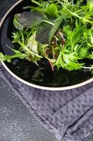 green salad leaves mix mix micro green, healthy snack food on the table copy space food background rustic top view photo