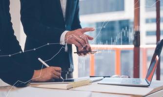investment strategy, financial business plan concept, business partner, colleagues, staff meeting in office using computer laptop on table with virtual graph, data analysis profit growth. photo