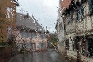 Raindrops on the glass, blurred background. outdoors photo