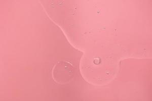 pink background with transparent bubbles serum photo