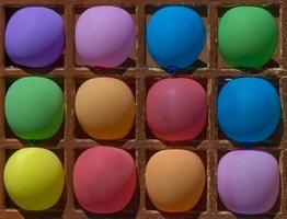 close up of dart game with color balloons photo