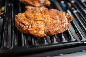 pork neck grilled on a gas grill. Closeup photo