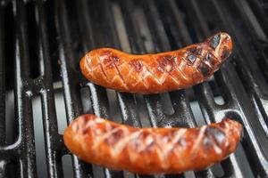 sausage grilled on a gas grill in closeup photo