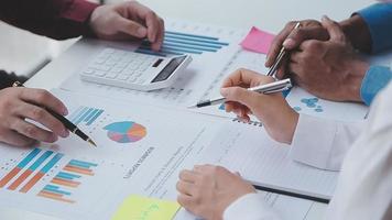 Financial analysts analyze business financial reports on a digital tablet planning investment project during a discussion at a meeting of corporate showing the results of their successful teamwork. video