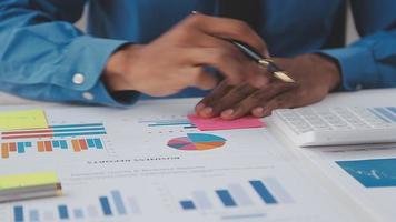Financial analysts analyze business financial reports on a digital tablet planning investment project during a discussion at a meeting of corporate showing the results of their successful teamwork. video