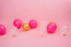 Beautiful multicolored pink, gold and transparent with confetti or sequins lie on a pink background in a chaotic order. Concept of Valentine's day, birthday, mother's day in barbiecore style photo