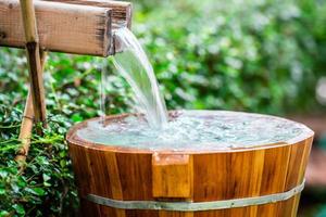 Wooden barrels for natural onsen, steam hot water from natural hot springs, soft focus. photo