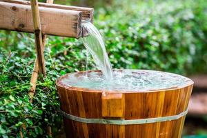 Wooden barrels for natural onsen, steam hot water from natural hot springs, soft focus. photo
