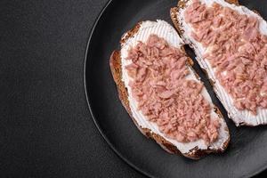 Delicious sandwiches consisting of grilled toast, canned tuna and cream cheese photo