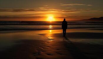 Photo of a sunset silhouette with a person standing on a beach at sunset.