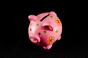 Piggy bank isolated on black background photo