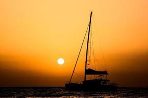 Sailing yacht at sunset photo