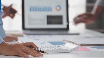 Financial analysts analyze business financial reports on a digital tablet planning investment project during a discussion at a meeting of corporate showing the results of their successful teamwork. video