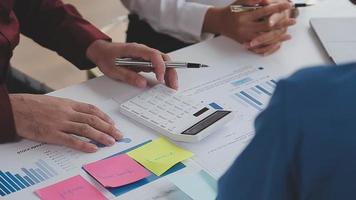 Financial analysts analyze business financial reports on a digital tablet planning investment project during a discussion at a meeting of corporate showing the results of their successful teamwork. video