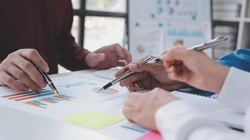 Financial analysts analyze business financial reports on a digital tablet planning investment project during a discussion at a meeting of corporate showing the results of their successful teamwork. video