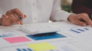 Financial analysts analyze business financial reports on a digital tablet planning investment project during a discussion at a meeting of corporate showing the results of their successful teamwork. video