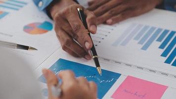 Financial analysts analyze business financial reports on a digital tablet planning investment project during a discussion at a meeting of corporate showing the results of their successful teamwork. video