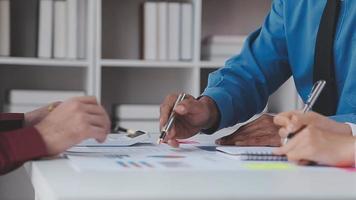 Financial analysts analyze business financial reports on a digital tablet planning investment project during a discussion at a meeting of corporate showing the results of their successful teamwork. video
