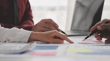 Financial analysts analyze business financial reports on a digital tablet planning investment project during a discussion at a meeting of corporate showing the results of their successful teamwork. video