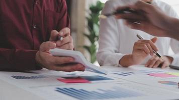 Financial analysts analyze business financial reports on a digital tablet planning investment project during a discussion at a meeting of corporate showing the results of their successful teamwork. video