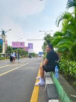 Bekasi, Indonesia - March,12 2023 A man is yawning at the car free day event in Bekasi city photo