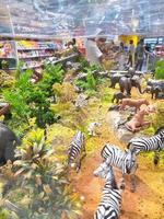 Miniature toy animals in glass cases for sale in a shop photo