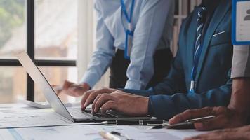 Financial analysts analyze business financial reports on a digital tablet planning investment project during a discussion at a meeting of corporate showing the results of their successful teamwork. video