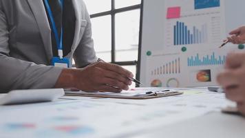 Financial analysts analyze business financial reports on a digital tablet planning investment project during a discussion at a meeting of corporate showing the results of their successful teamwork. video