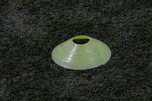yellow marker on the artificial green field of the football field photo