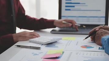Financial analysts analyze business financial reports on a digital tablet planning investment project during a discussion at a meeting of corporate showing the results of their successful teamwork. video