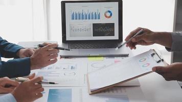 Financial analysts analyze business financial reports on a digital tablet planning investment project during a discussion at a meeting of corporate showing the results of their successful teamwork. video