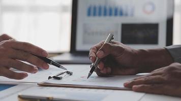 Financial analysts analyze business financial reports on a digital tablet planning investment project during a discussion at a meeting of corporate showing the results of their successful teamwork. video