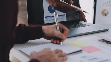 Group of confident business people point to graphs and charts to analyze market data, balance sheet, account, net profit to plan new sales strategies to increase production capacity. video