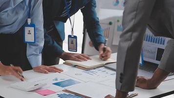 Financial analysts analyze business financial reports on a digital tablet planning investment project during a discussion at a meeting of corporate showing the results of their successful teamwork. video