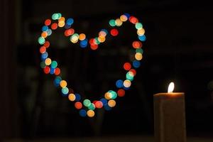 Candles light with background bokeh like a heart. Abstract candle background. Horizontal view. photo