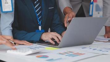 Financial analysts analyze business financial reports on a digital tablet planning investment project during a discussion at a meeting of corporate showing the results of their successful teamwork. video