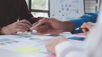 Financial analysts analyze business financial reports on a digital tablet planning investment project during a discussion at a meeting of corporate showing the results of their successful teamwork. video