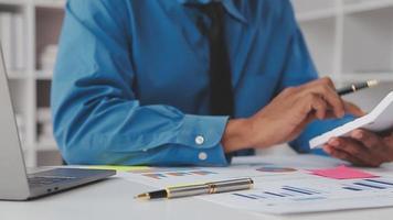 Financial analysts analyze business financial reports on a digital tablet planning investment project during a discussion at a meeting of corporate showing the results of their successful teamwork. video