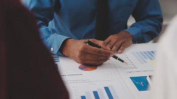 Financial analysts analyze business financial reports on a digital tablet planning investment project during a discussion at a meeting of corporate showing the results of their successful teamwork. video
