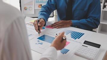 Financial analysts analyze business financial reports on a digital tablet planning investment project during a discussion at a meeting of corporate showing the results of their successful teamwork. video