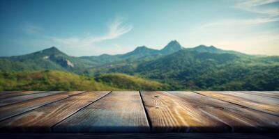 Empty wooden table with green mountain background, Free space for product display. photo