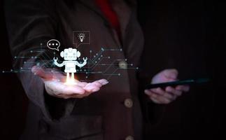 chatGPT, Businessman hand holding a robot hologram with social media icons. conversationa AI. photo